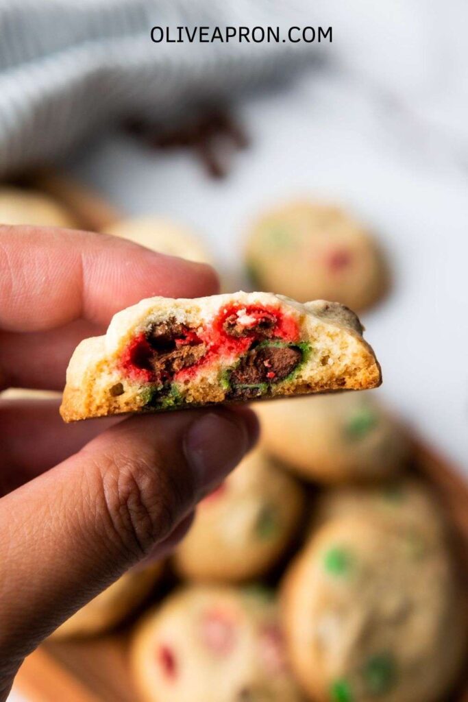 Close up of a handheld baked Mm Christmas cookie.