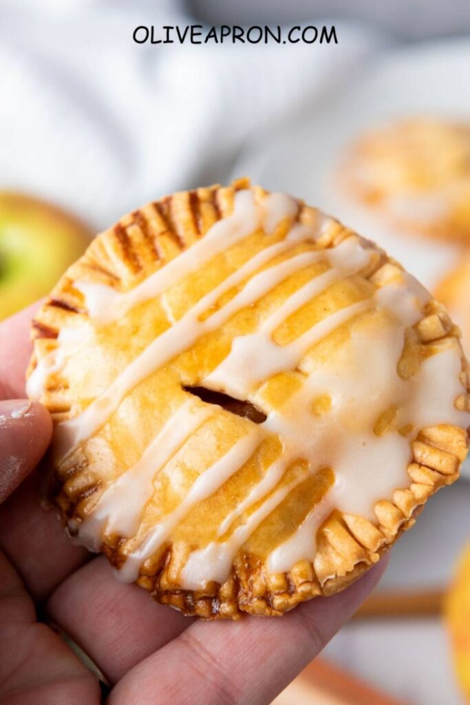 Homemade mini apple pie bite with glaze – handheld apple tart for fall treats.