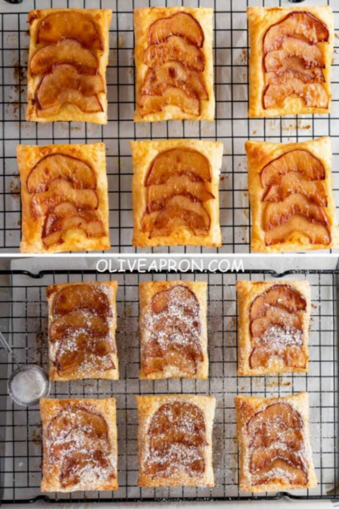 Freshly baked mini apple puff pastry tarts cooling on a wire rack, dusted with powdered sugar.