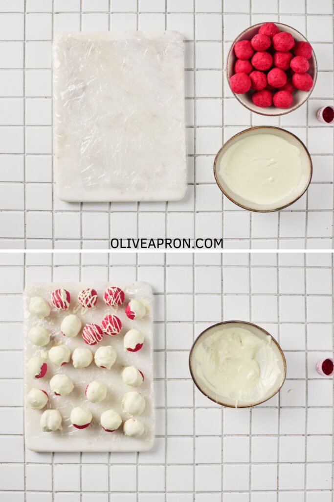 Red velvet truffle balls dipped in melted white chocolate and set on a tray to dry.