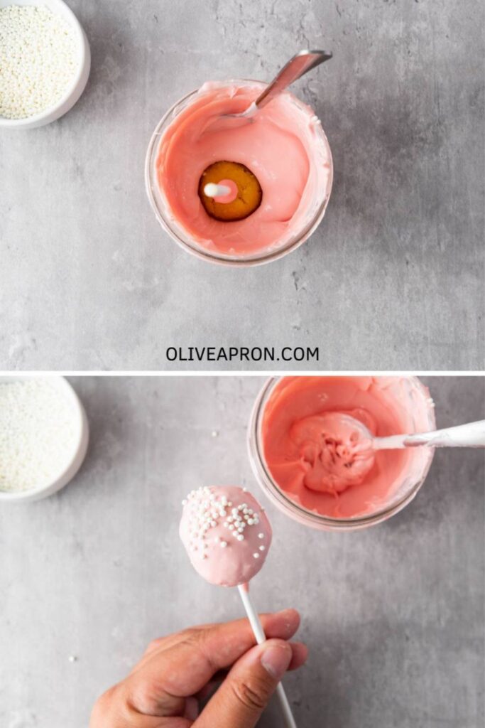 Pink cake pop being dipped in melted candy coating and finished with white sprinkles