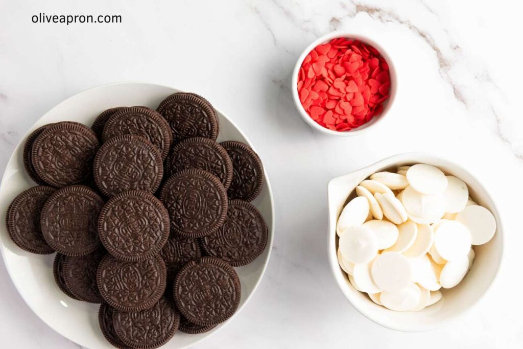 Valentine Oreos ingredients: a plate with Oreo cookies, and red and white candy melts.