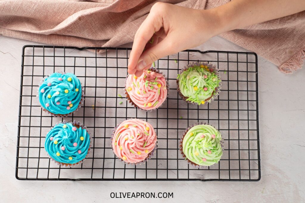Adding sprinkles on top of icing