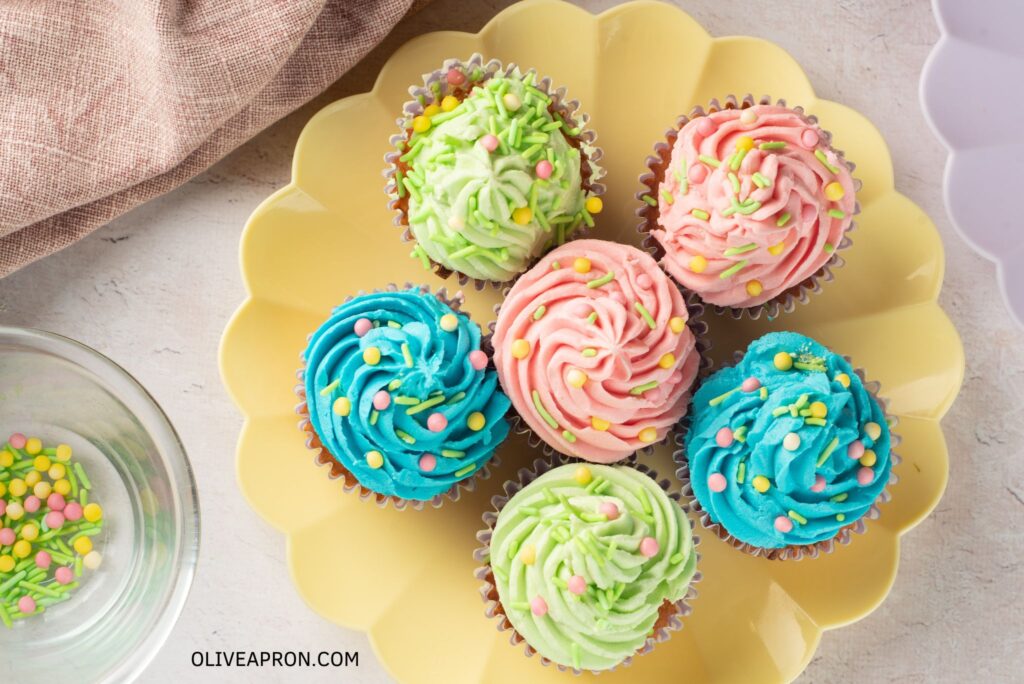 Top view of Easter cupcakes displayed on a yellow serving dish