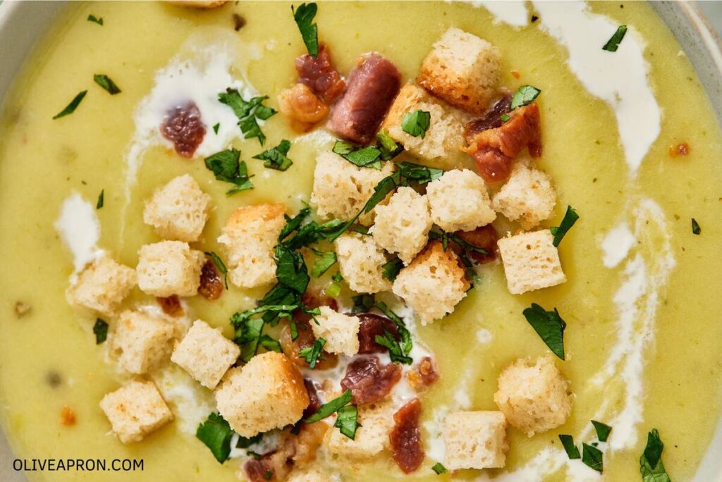Creamy potato soup with bacon and croutons close up