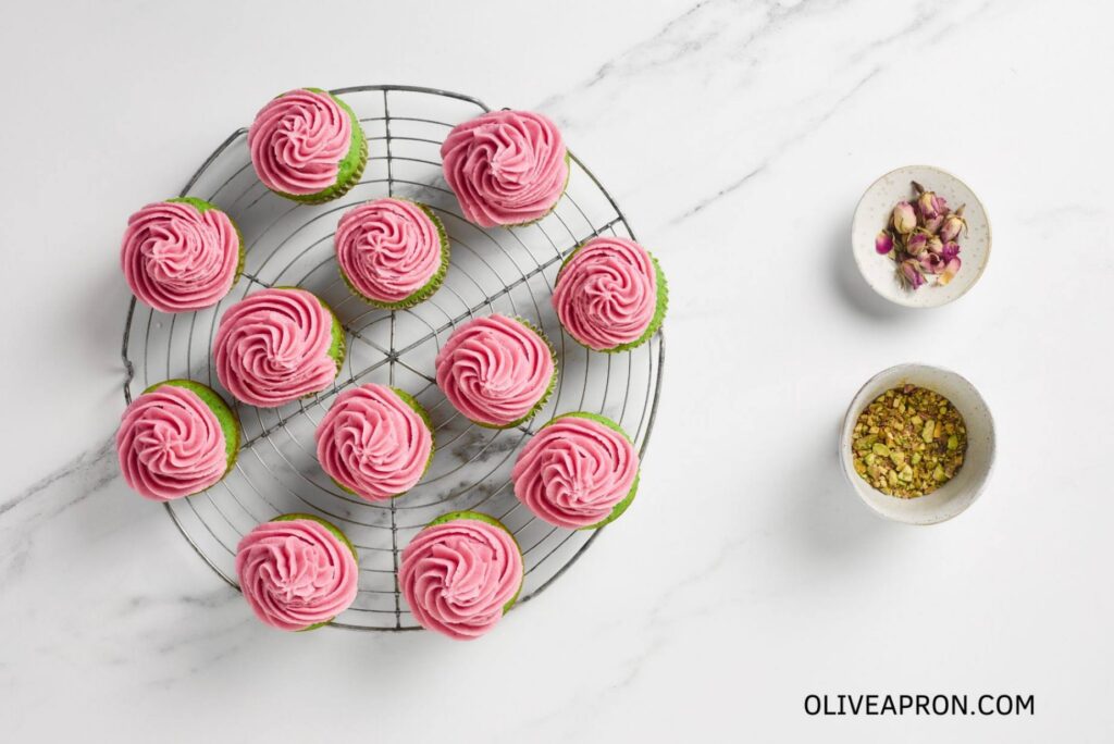 Pink pistachio Cupcakes in cooling rack wire