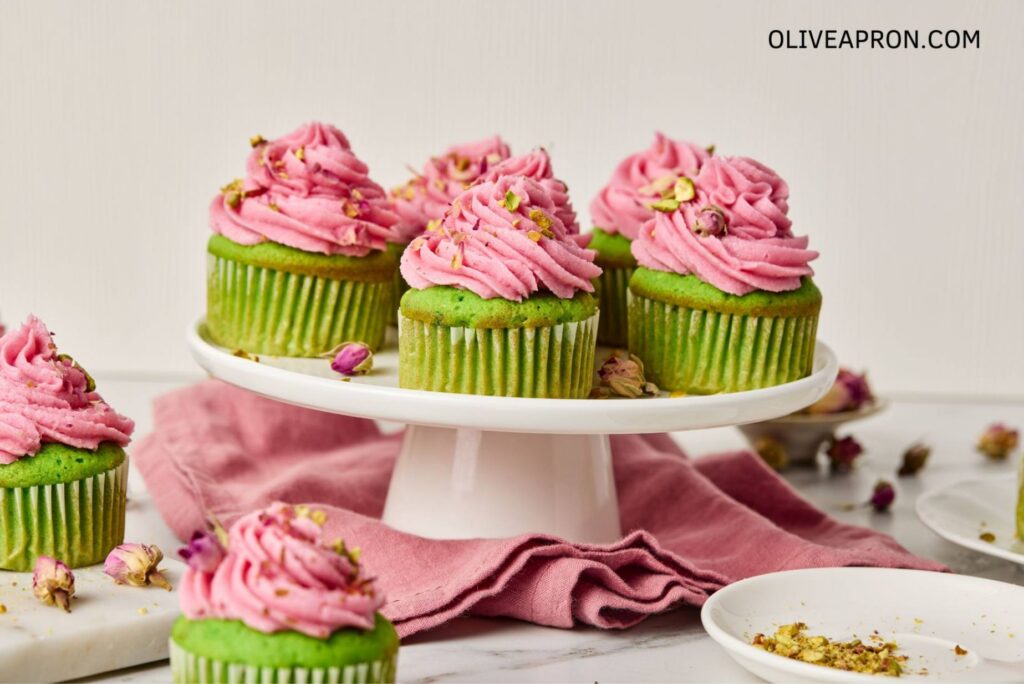 Pistachio cupcakes with rosewater frosting on display