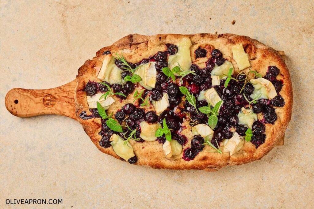 Garnish baked flatbread with fresh herbs