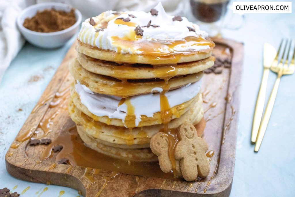 Gingerbread pancakes with whipped cream and syrup