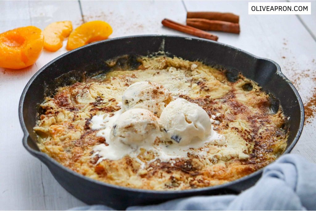 Skillet peach dump cake served with ice cream
